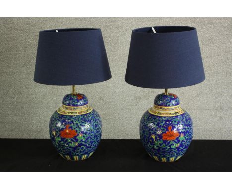 A contemporary pair of Chinese porcelain table lamps, with scroll and floral decoration. H.50 Dia. 20cm. (each) 