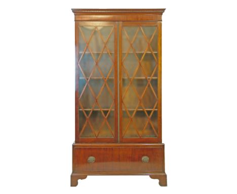 Georgian style mahogany cabinet bookcase having a moulded dentil cornice fitted four shelves enclosed by a pair of glazed doo