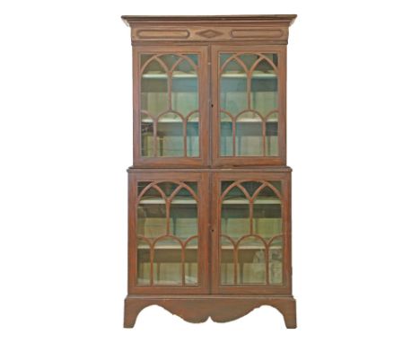 19th Century stained pine two section cabinet bookcase, the upper section fitted three shelves enclosed by a pair of glazed d