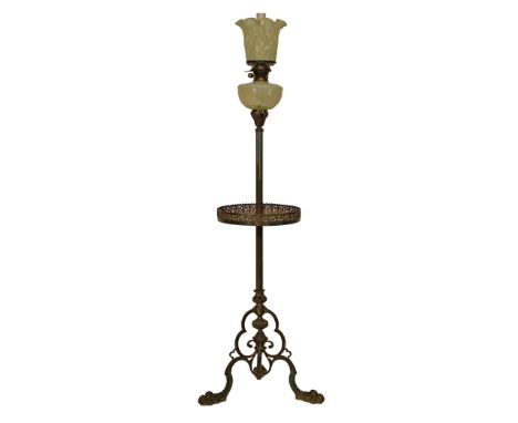 Late 19th/early 20th Century brass floor standing oil lamp having a reeded column with galleried platform and standing on a t