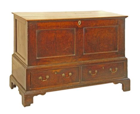 George III oak mule chest, the hinged cover opening to reveal a fitted interior with candle box and drawers, double panel fro