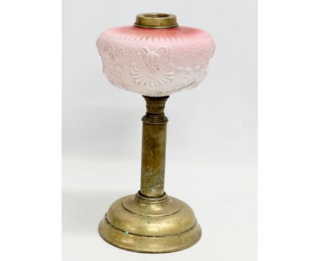 A Victorian embossed milk glass oil lamp with brass column. 35cm 