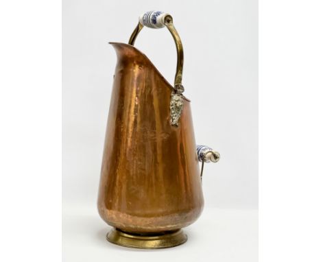 A vintage copper coal scuttle with ceramic and brass handles. 46cm 