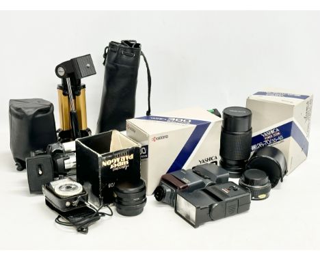 A collection of camera equipment. Yashica lens, flash etc. Subagor camera stand and other. Super Paragon lens etc 