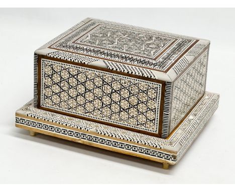 A Mother of Pearl inlaid musical cigarette box. 19x17x11cm 