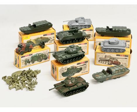 A collection of vintage Airfix HO-OO scale vehicles with boxes and soldiers. 