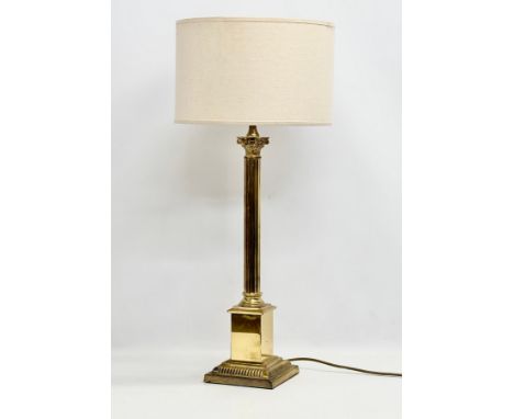 A large 20th Century brass table lamp with Corinthian column. Base measures 17x17x64cm 