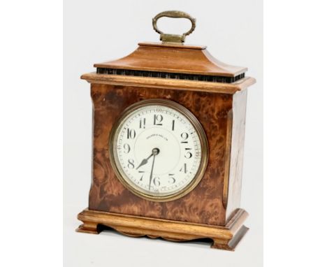 An Early 20th Century Walker &amp; Hall burr walnut mantle clock. French works. 16x8x21cm 