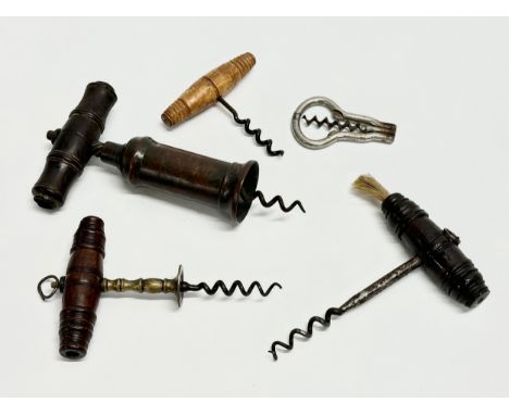 A good collection of 19th Century corkscrews with turned handles. A large barrel shaped corkscrew 18cm. 