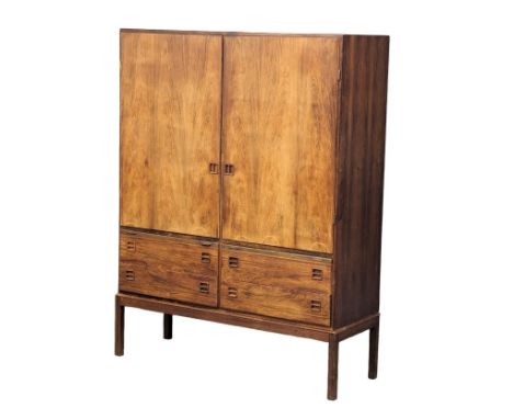 A Danish Mid Century rosewood cabinet designed by Johannes Andersen for Bernhard Pedersen &amp; Son, Denmark, 1960s. With 4 d