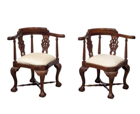 A pair of Chippendale Style mahogany corner armchairs on ball and claw feet. 