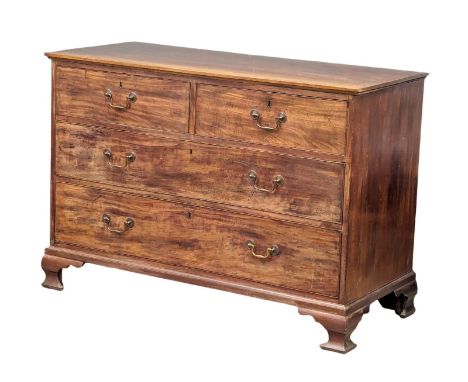 A George III mahogany oak lined chest of drawers on ogee feet and original brass drop handles. Circa 1800. 125.5x56x88cm 