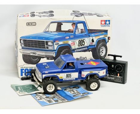 A Tamiya Riko Ford F 150 Ranger XLT radio control pick up truck with box. 1/10 scale. Remote and charger included. 