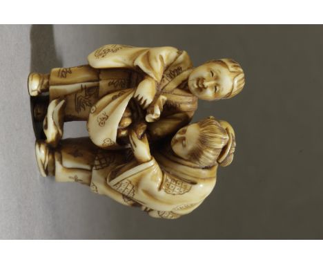 A mid 19th century Japanese netsuke. Signed Jugyoku II on the back. In carved elephant tusk offering goods to a woman who car