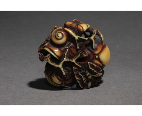 A 19th century netsuke manju ryusa. Not signed. In carved elephant tusk portraying a group composed by a snail and a wasp ove