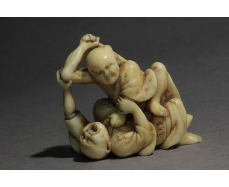 A mid 19th century Japanese netsuke from Edo period. Signed Harumin on the base. In carved elephant tusk portraying two men f