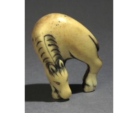 An early 19th century Japanese netsuke from Edo period. In carved bone portraying a standing horse with his head joined to hi