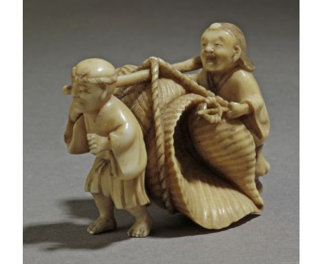 A mid 19th century Japanese netsuke from Edo period. Signed Tomomasa on the base. In carved elephant tusk portraying a fisher