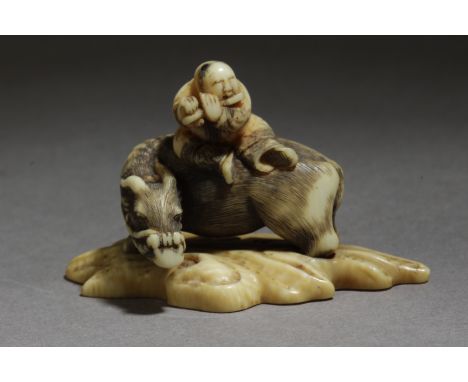 A mid 19th century Japanese netsuke from Edo period. In carved elephant tusk and horn porraying a karako playing the flute sa