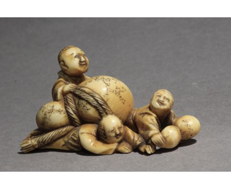 A late 19th century Japanese netsuke. Signed Katsura? on a red kanji on the base. In carved elephant tusk portraying a group 