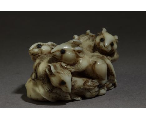 An early 19th century Japanese netsuke from Edo period. Not signed. In carved elephant tusk portraying a group of six rats pl