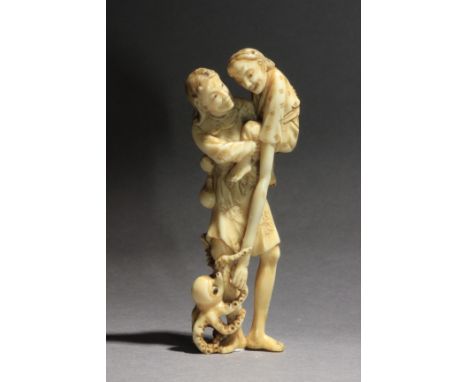A Japanese netsuke from Edo period circa 1800. Signed Hidemasa on a side. In carved elephant tusk portraying a standing Ashin