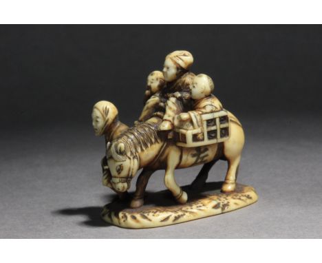 A 19th century Japanese netsuke-okimono. Signed Norishige on the base. In carved elephant tusk portraying a family group of c