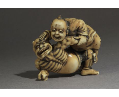 A mid 19th century Japanese netsuke from Edo period. Signed Mitsuaki on a side. In carved elephant tusk portraying a man figh