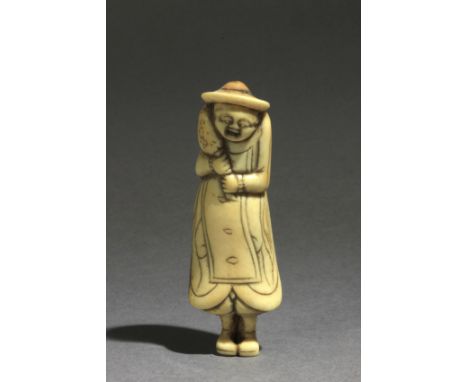 An early 18th century Japanese netsuke from Edo period. In carved bone portraying a standing Portuguese man wearing a hat and