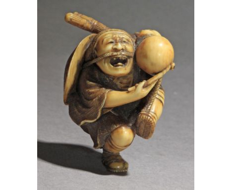 A late 19th century Japanese netsuke from Meiji period. Not signed. In carved ivory portraying a craftsman dancing, playing a