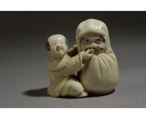 A late 19th century Japanese netsuke from Meiji period. Not signed. In carved elephant tusk portraying a sat karako feeding a