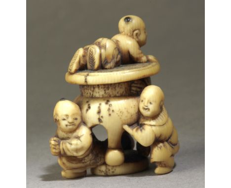 A mid 19th century Japanese netsuke. Signed Soko on the base. In carved elephant tusk portraying a group of two kids resting 