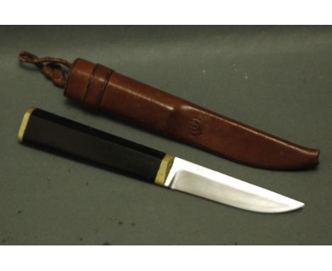 A fixed blade knife with leather sheath marked with a bear print.  Blade length 4", overall length 21 cm.