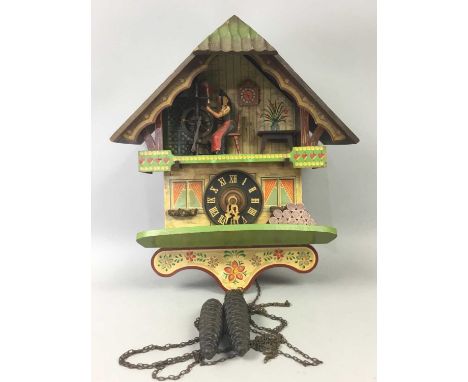 20TH CENTURY CUCKOO CLOCK,modelled with lady by spinning wheel, 36cm high