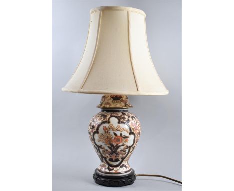 An Oriental Ceramic Table Lamp in the Form of a Vase, With Shade 