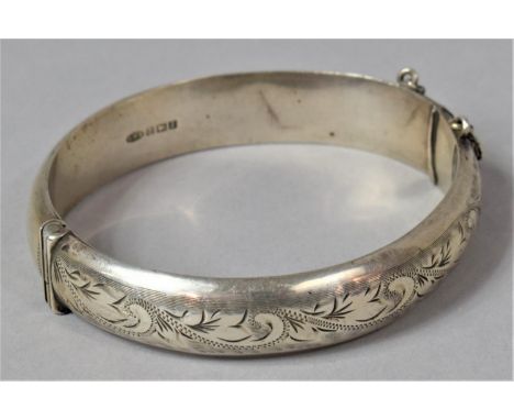 A Silver Bangle with Engraved Floral Decoration, With Safety Chain, Birmingham 1966 