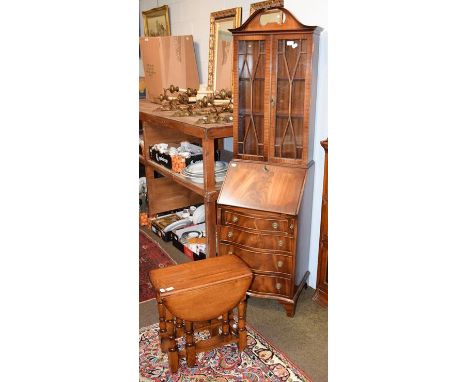 A reproduction mahogany slender bureau bookcase, together with an oak gate leg occasional table (2)