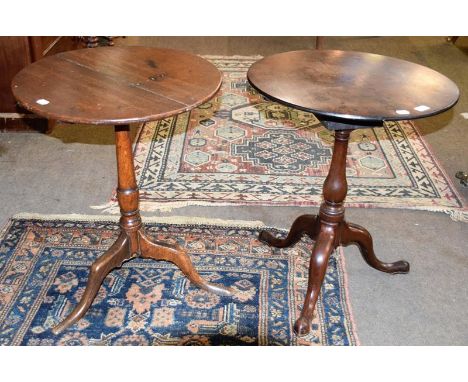 A George III oak snap top tripod table, rotating on a bird cage mechanism, 58cm diameter by 70cm, together with another oak t