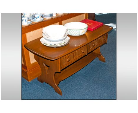 Ercol Golden Dawn Colour Coffee Table in the Jacobean style with two carved front doors. Supported by shaped side supports an