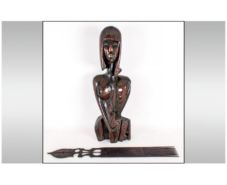 Modernist Wood Sculpture in the form of a African stylised figure 24 inches high. Together with a carved wooden comb.