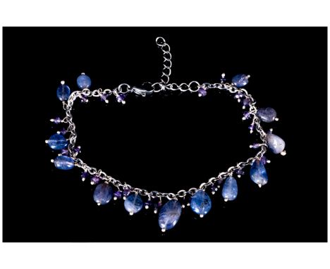 Tanzanite and Amethyst Charm Bracelet, polished ovoid tanzanites and small faceted amethysts suspended from a belcher chain b