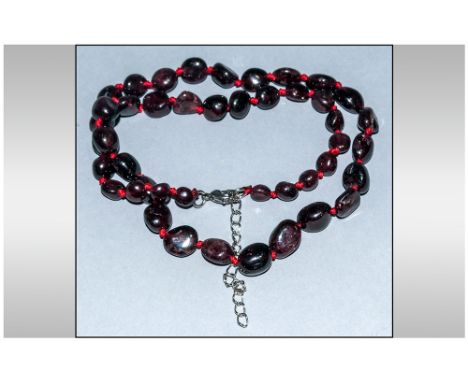 Red Garnet Bead Necklace, polished, ovoid, Indian red garnets, knotted onto red silk and fastened with a lobster claw clasp; 