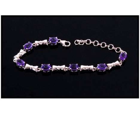 Amethyst Ovals and Bows Bracelet, 8.5cts of oval cut amethysts interspaced with platinum vermeil and silver bows, fastened wi