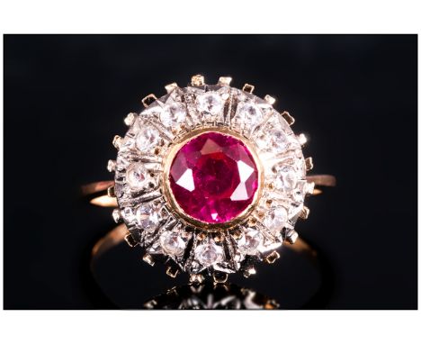 Ladies 9ct Gold Ruby and Diamond Cluster Ring. The Circular Shaped Ruby Surrounded by 12 Small Diamonds. 