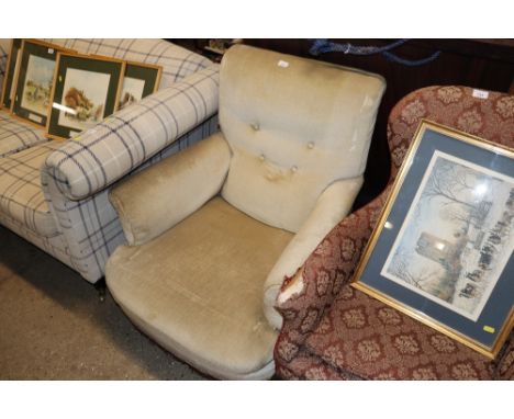 A late Victorian deep seated easy chair upholstered in fawn button Dralon raised on turned front supports 