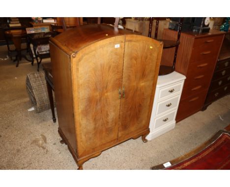 A walnut cabinet, the interior fitted three drawers raised on squat cabriole supports 