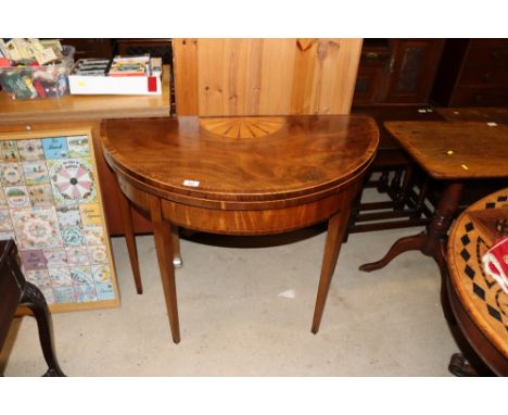 An early 19th Century mahogany rose wood cross banded and satin wood strung demi lune card table raised on square tapering su