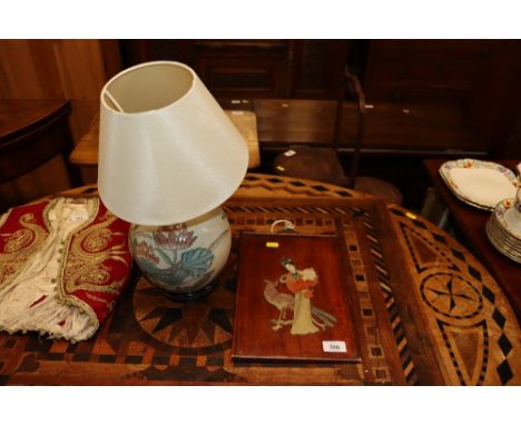 An Oriental decorated table lamp and shade together with a wooden panel with carved stone decoration depicting a peacock and 