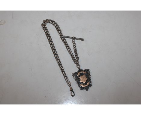 A heavy graduated silver watch chain with dog clip and T bar; a large silver shield shape fob, approx. 95gms