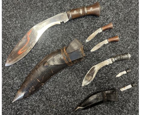 Pair of Kukri Knives: One with single edged 30cm long plated blade, no markings. Wooden grips. Overall length 430mm. Complete